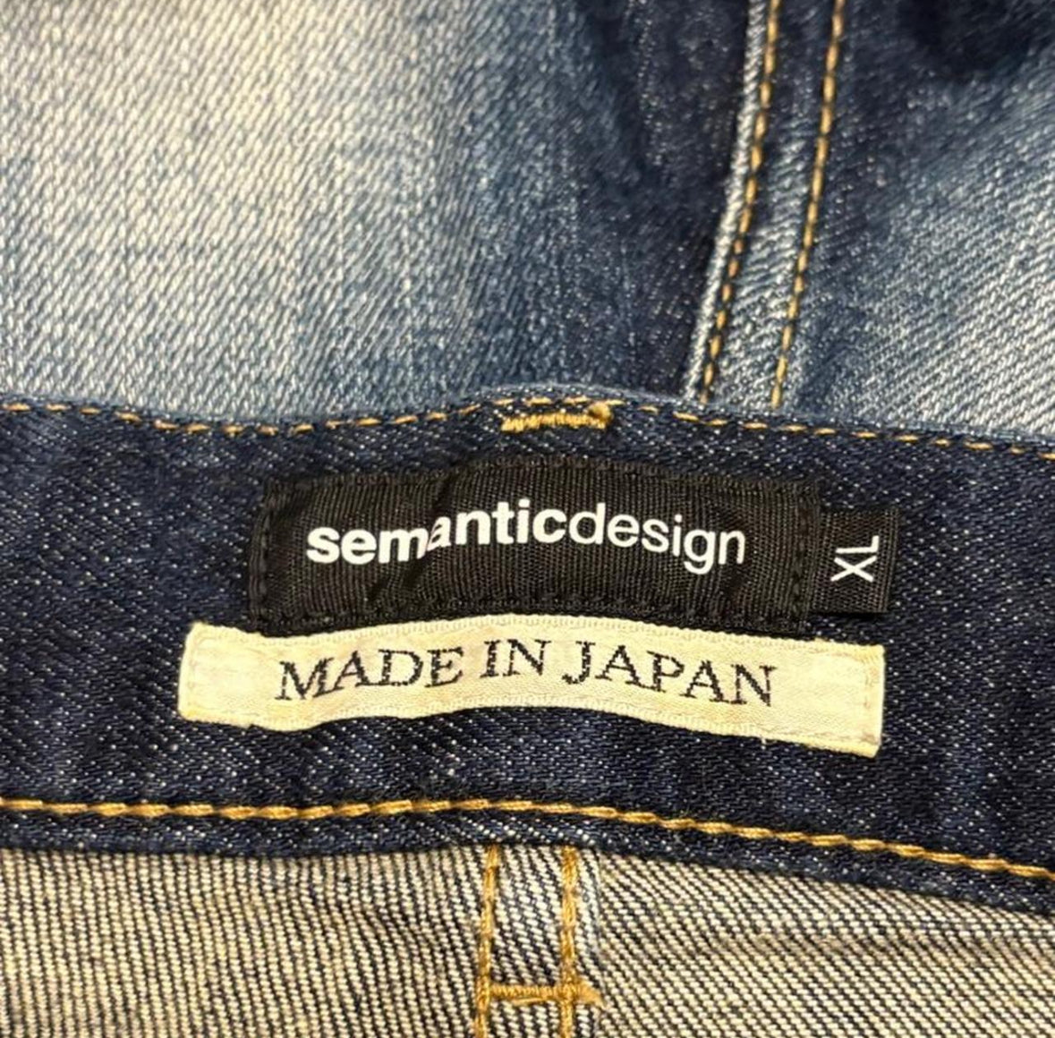 Semantic Design blue paint splatter denim jeans