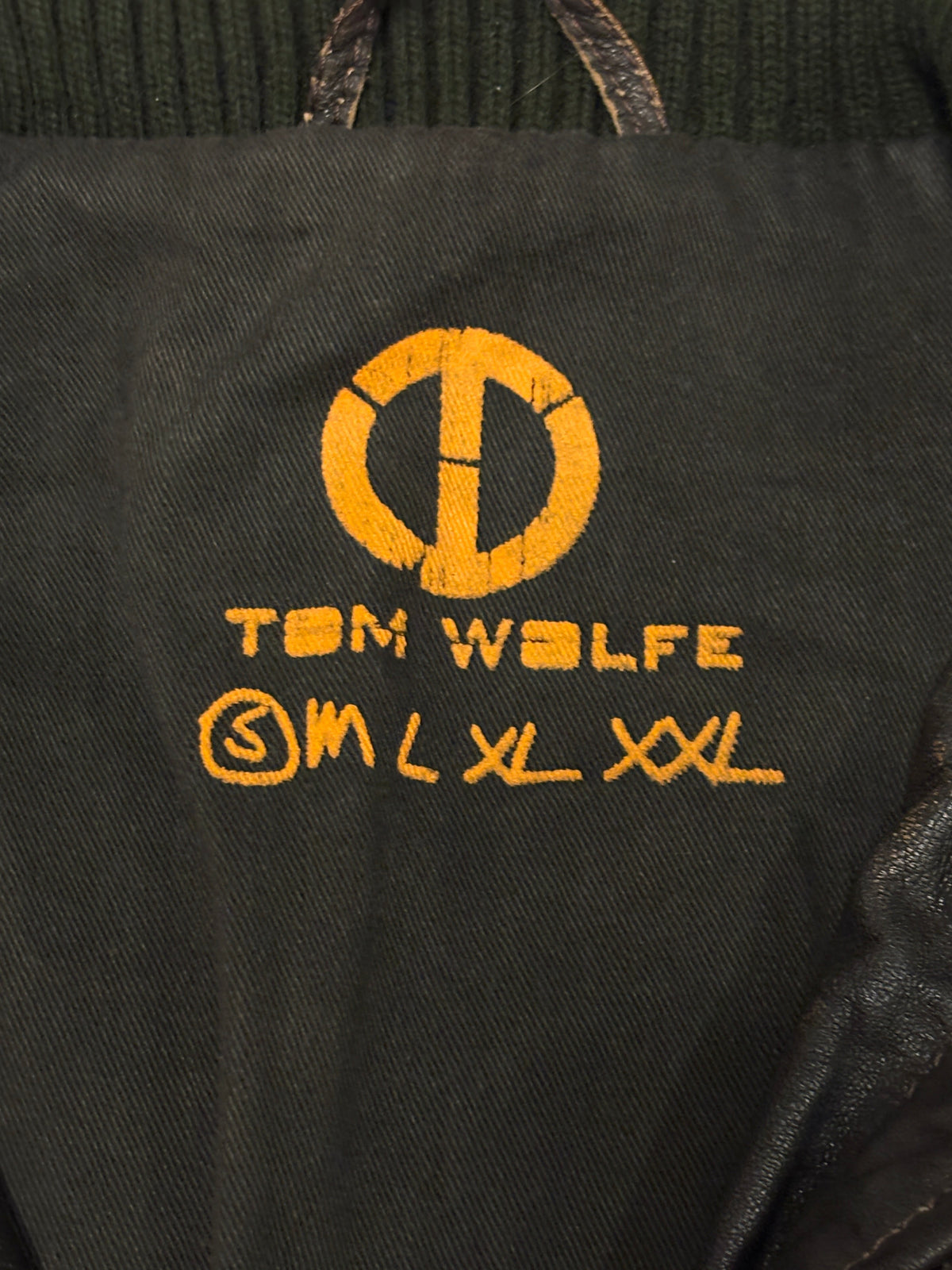 Tom Wolfe black leather biker jacket with green cotton fleece ends