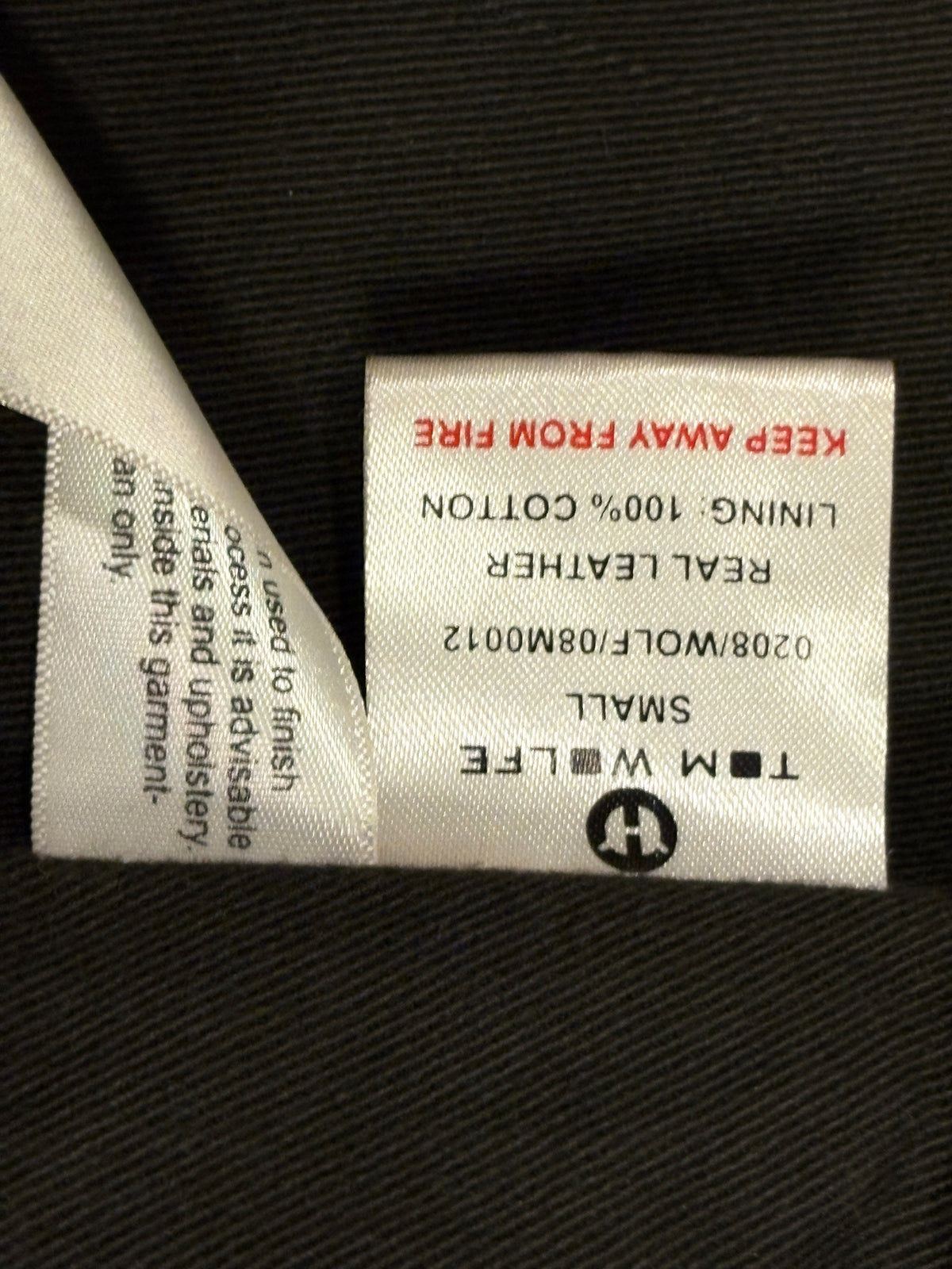 Tom Wolfe black leather biker jacket with green cotton fleece ends
